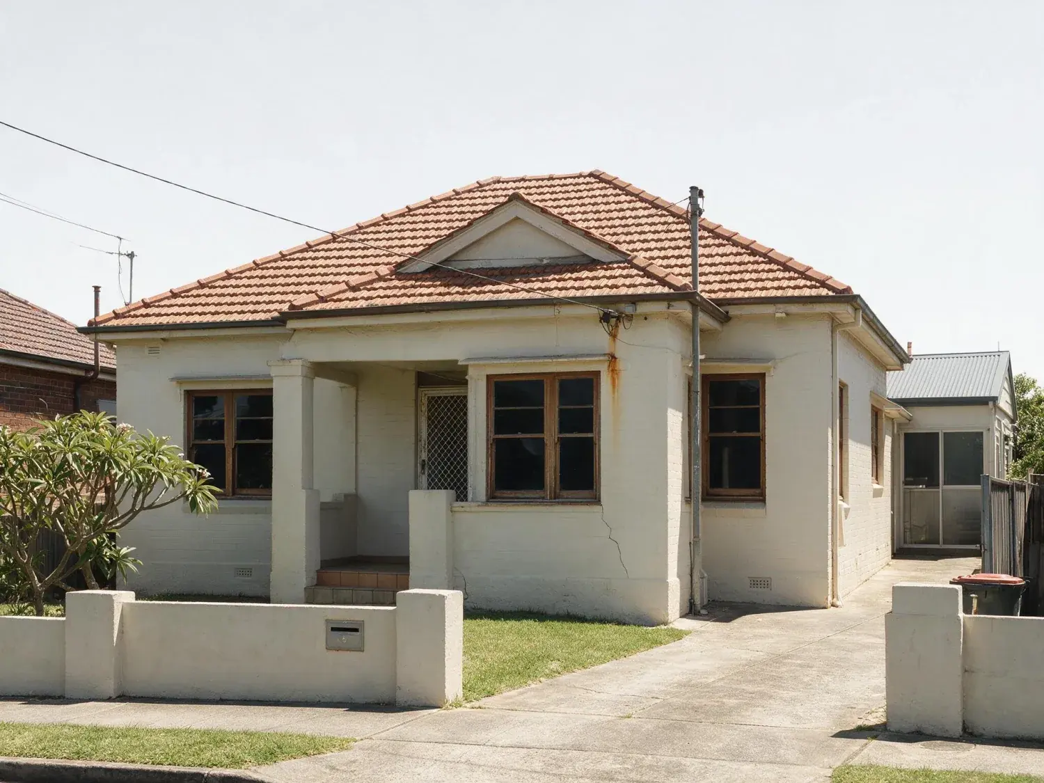 Before and after of a north bondi semi photographed at midday, sky bleached out, every window dark and no lights on inside — original listing photo before editing