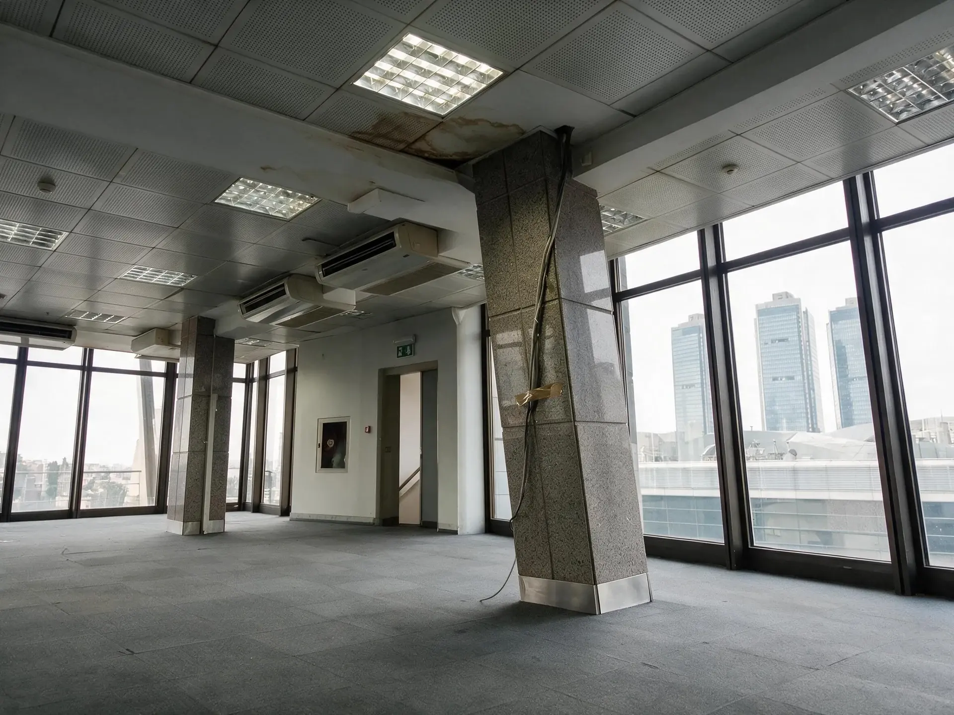 Before and after of a levent plaza floor photographed hand-held and tipped back, so every column and mullion leans in
