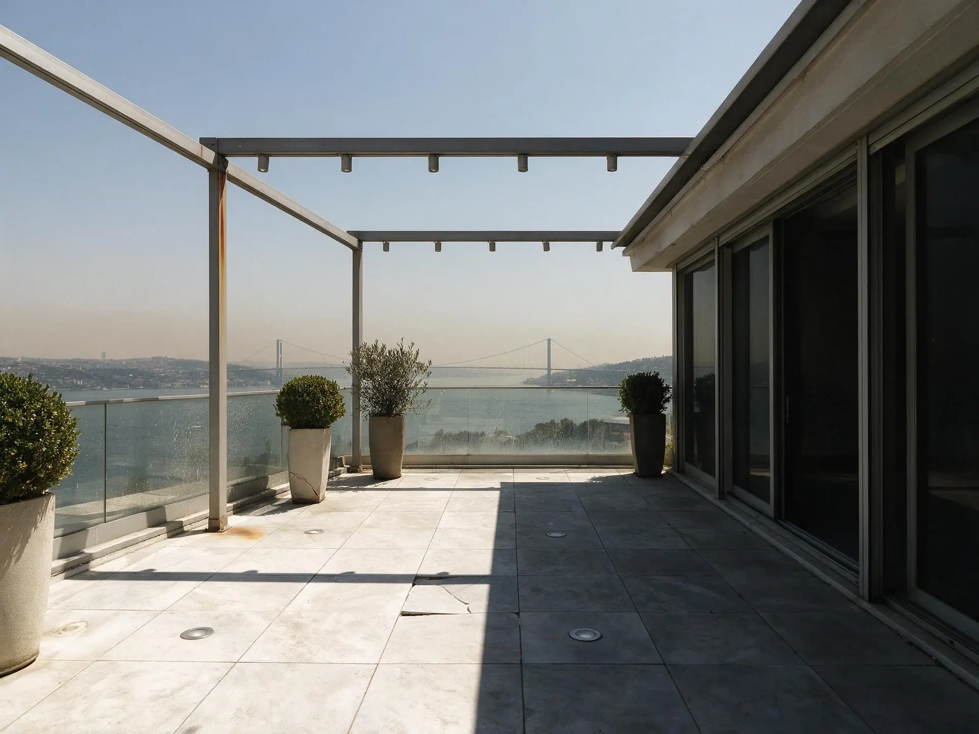 Before and after of a terrace residence overlooking the Bosphorus bridge in Istanbul converted to dusk. — original listing photo before editing