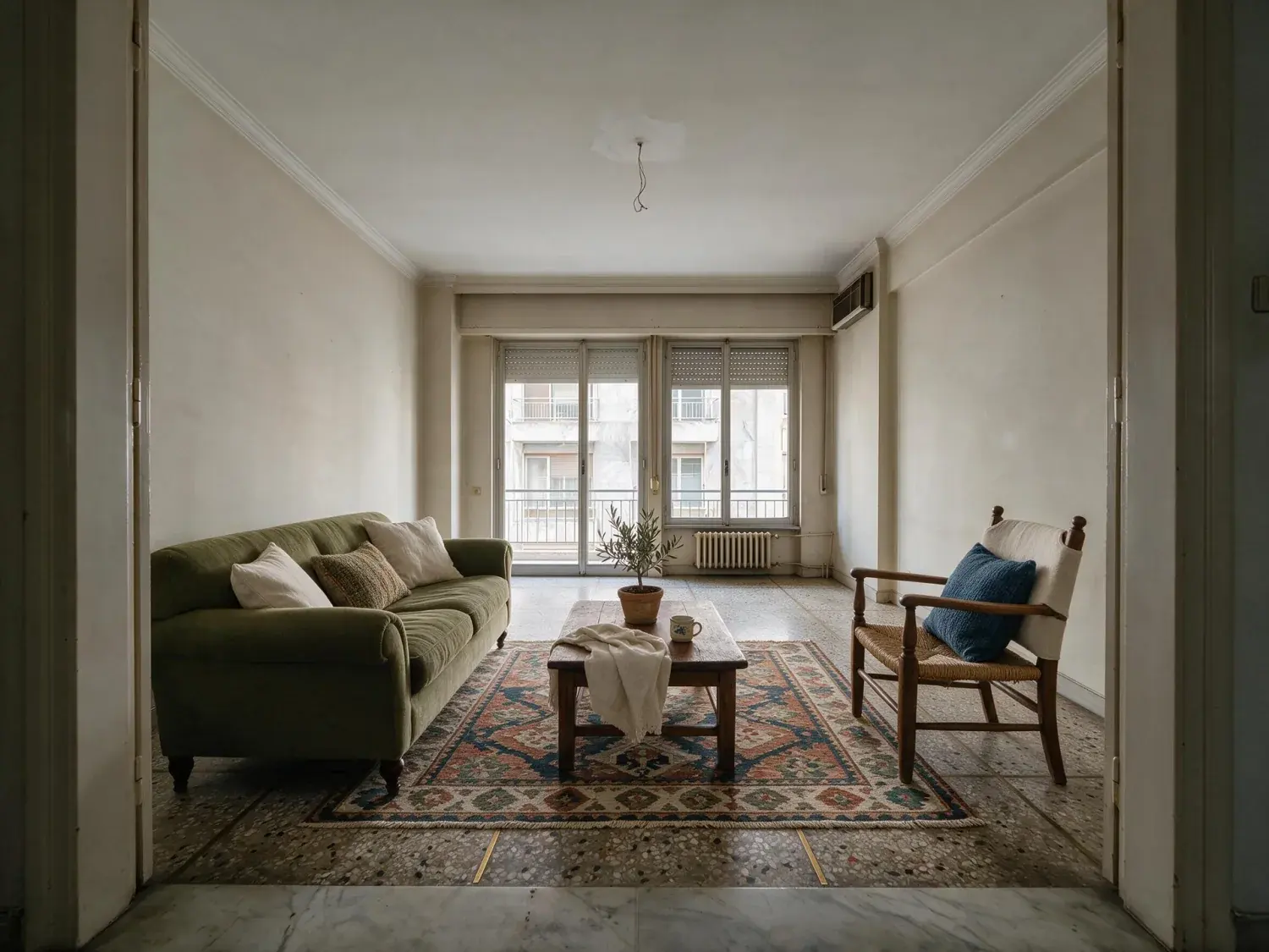 Before and after of an empty kolonaki living room furnished as a mediterranean short-let — enhanced by Plotpane