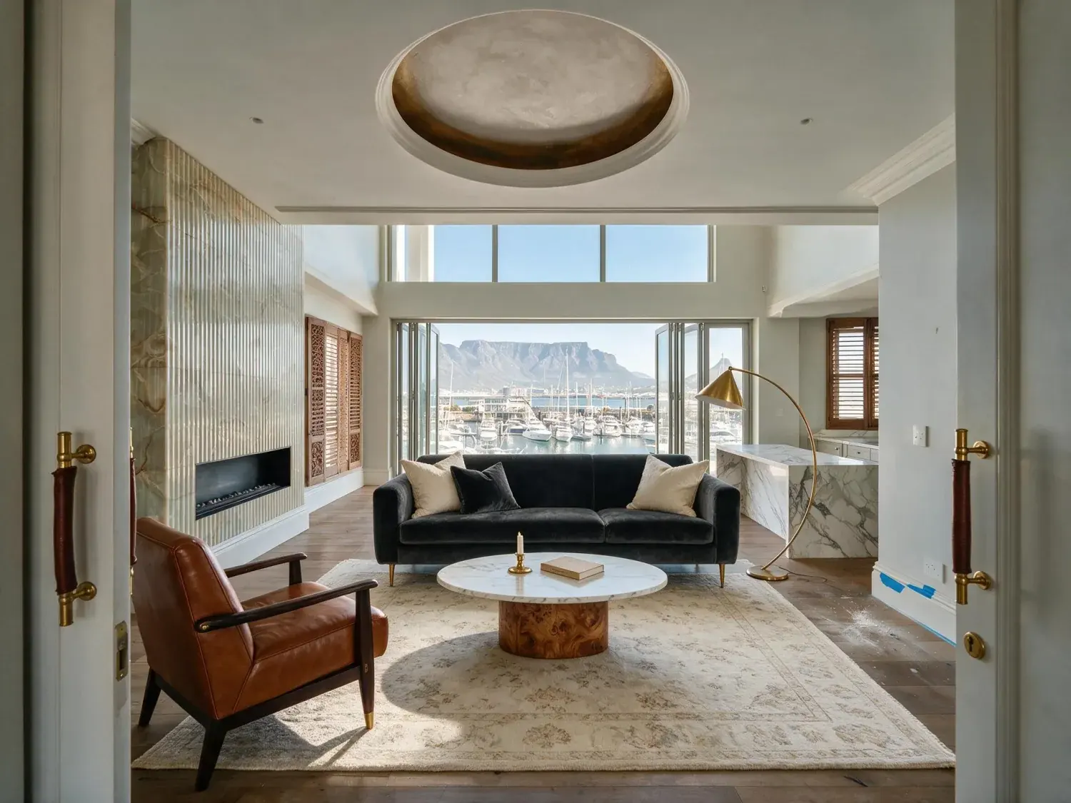 Before and after of an empty penthouse at one&only cape town is staged into a safari-lux salon, framing the existing table mountain and marina beyond — enhanced by Plotpane