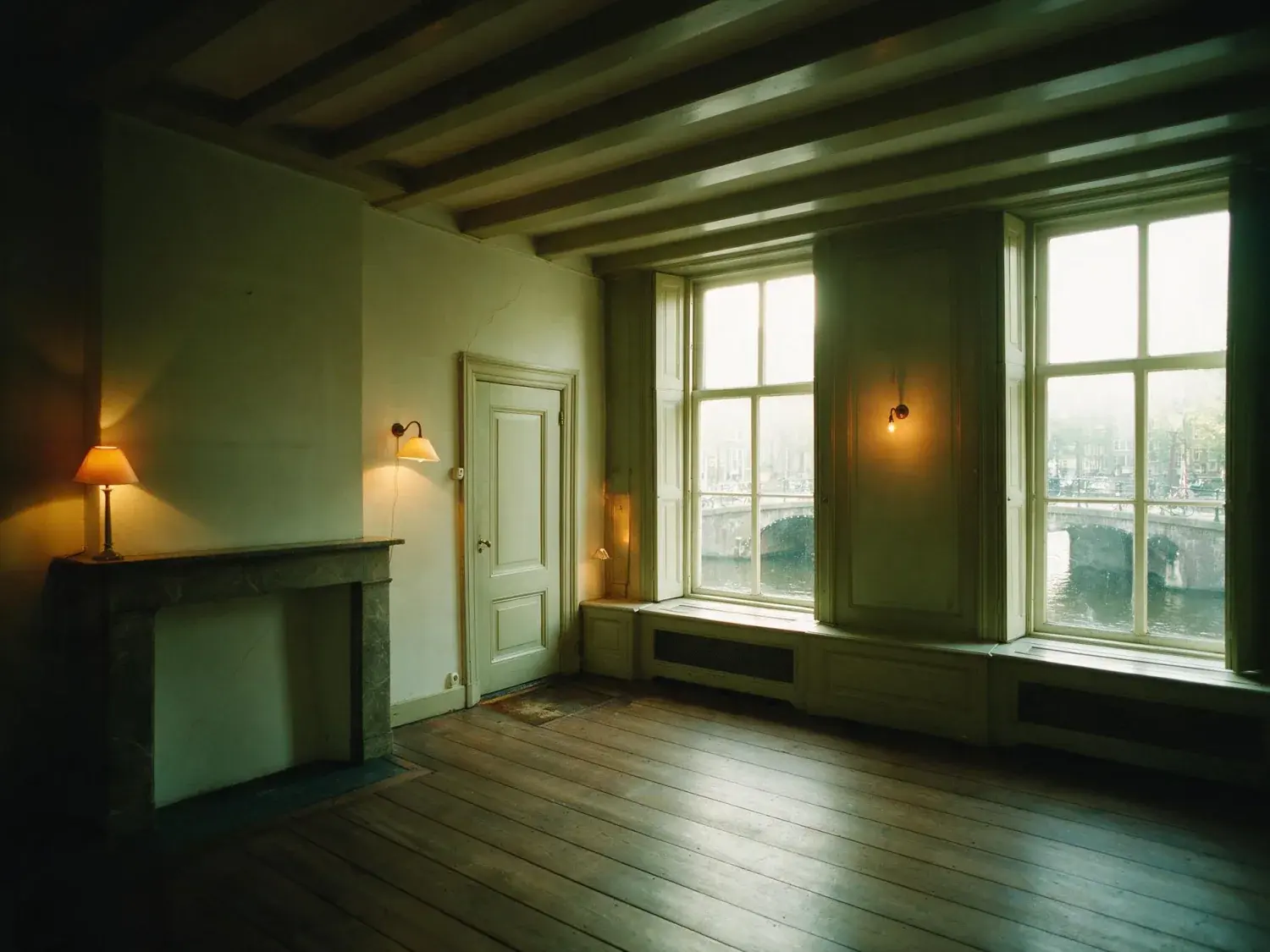 Before and after of an Amsterdam canal house bel-étage, dim with the canal window burnt out. — original listing photo before editing