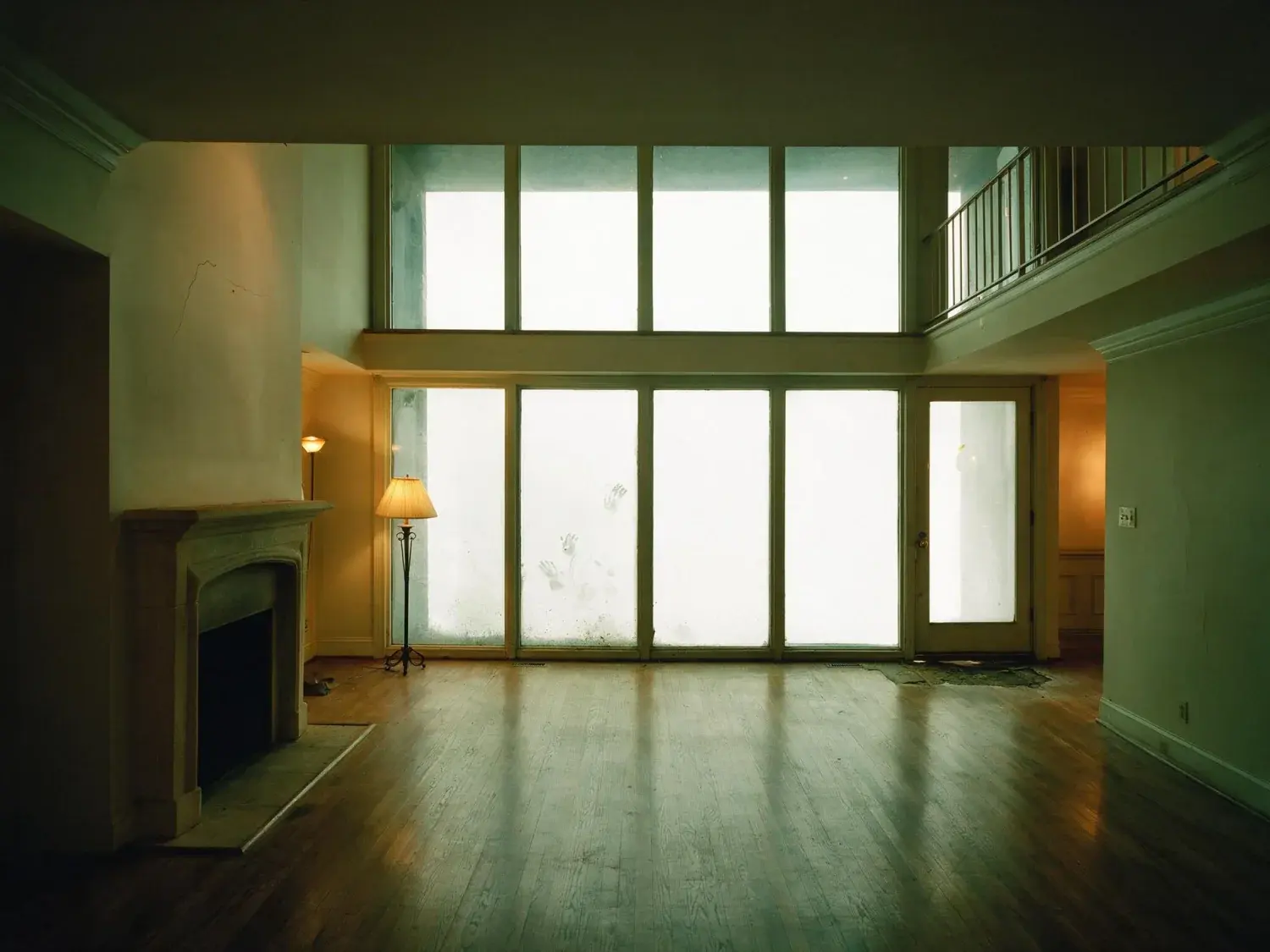 Before and after of a Buckhead townhouse great room, dark with the two-storey glass burnt out. — original listing photo before editing