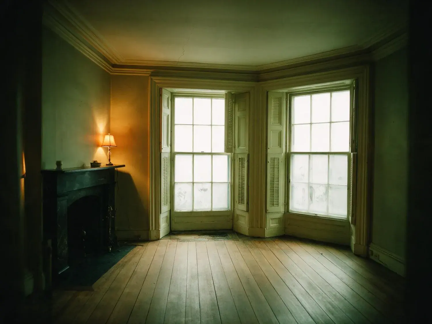 Before and after of a Back Bay brownstone parlour, dim with the street window blown out. — original listing photo before editing