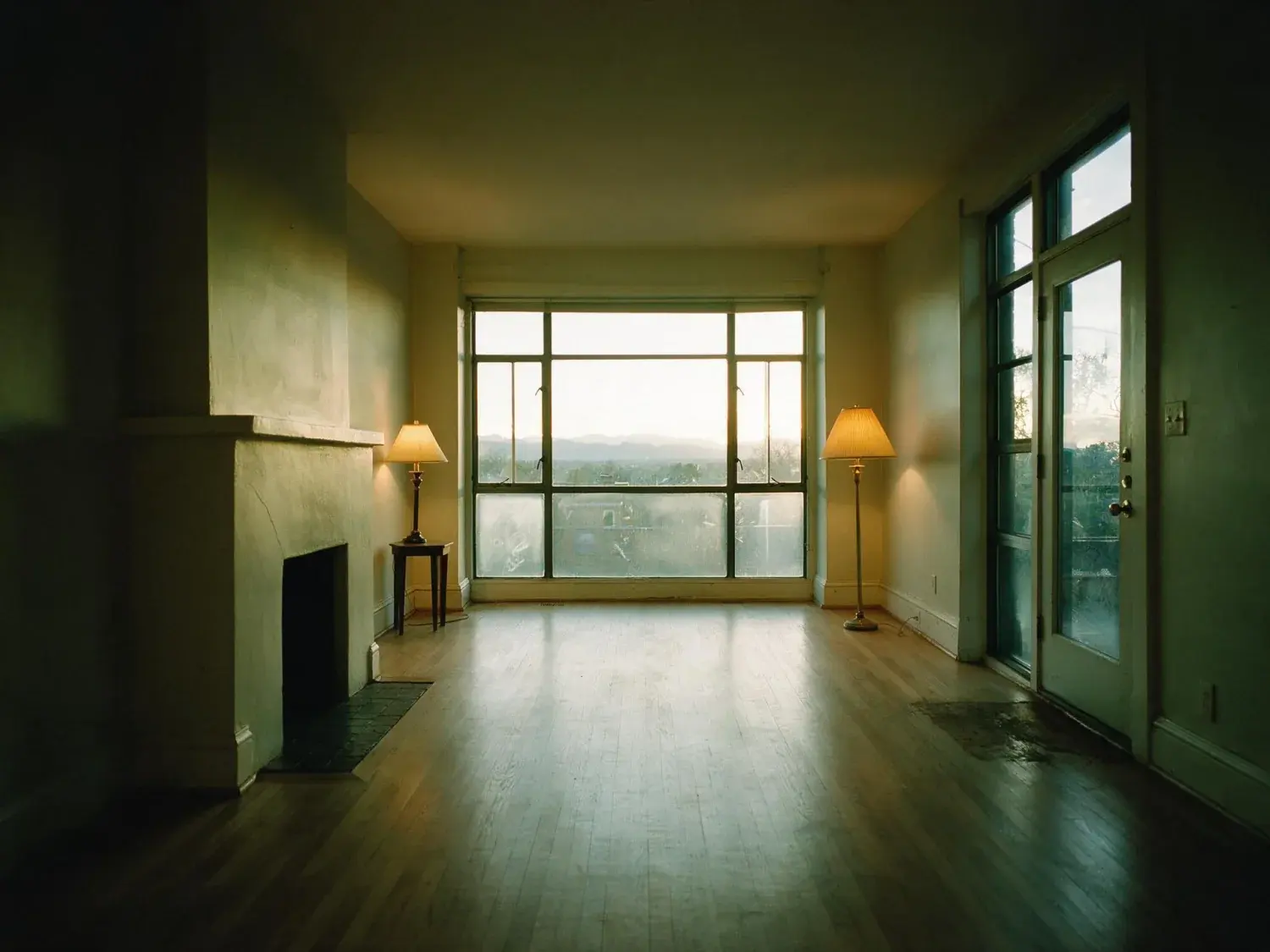 Before and after of a Cherry Creek row house, flat and dim with the window overexposed. — original listing photo before editing