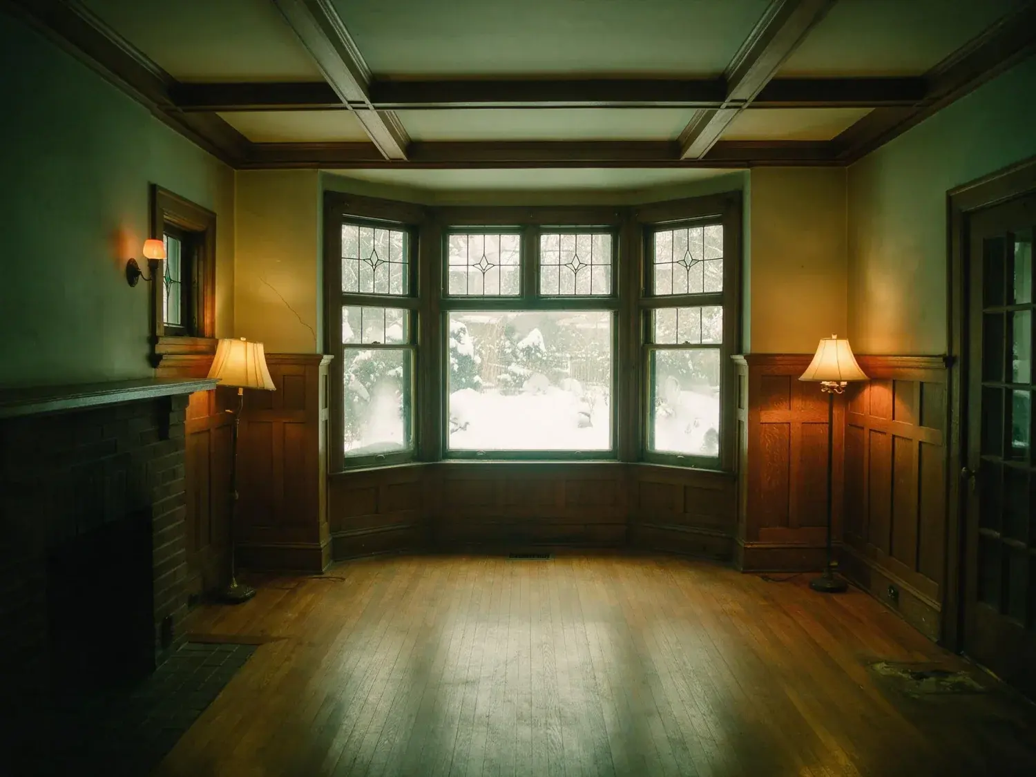 Before and after of a Rosedale living room, dim in winter light with the garden window blown out. — original listing photo before editing
