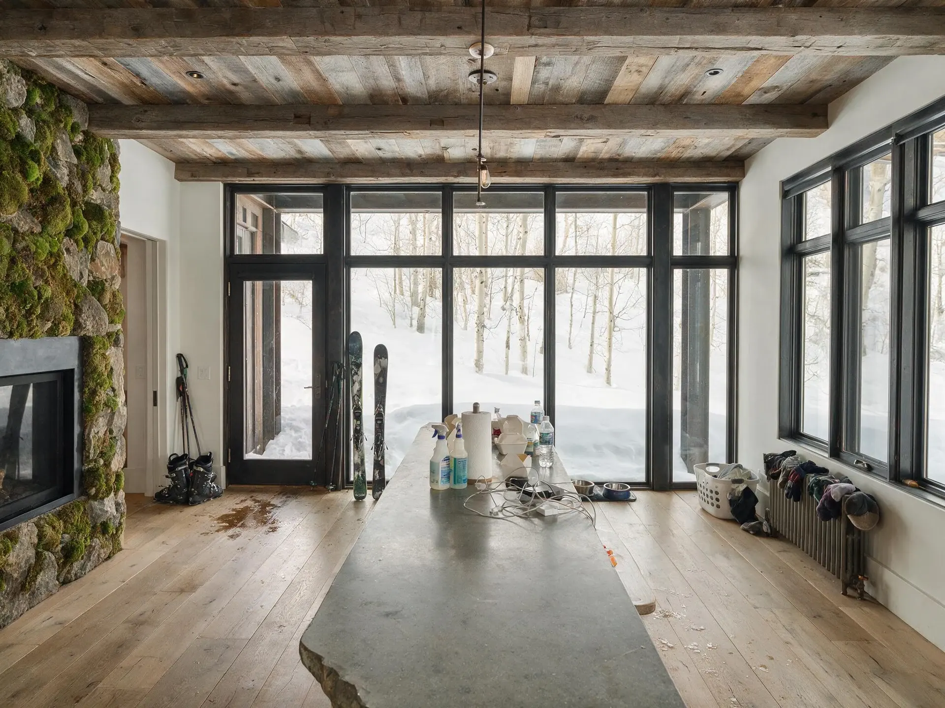 Before and after of a mountain house kitchen and great room in Aspen's West End with clutter removed. — original listing photo before editing