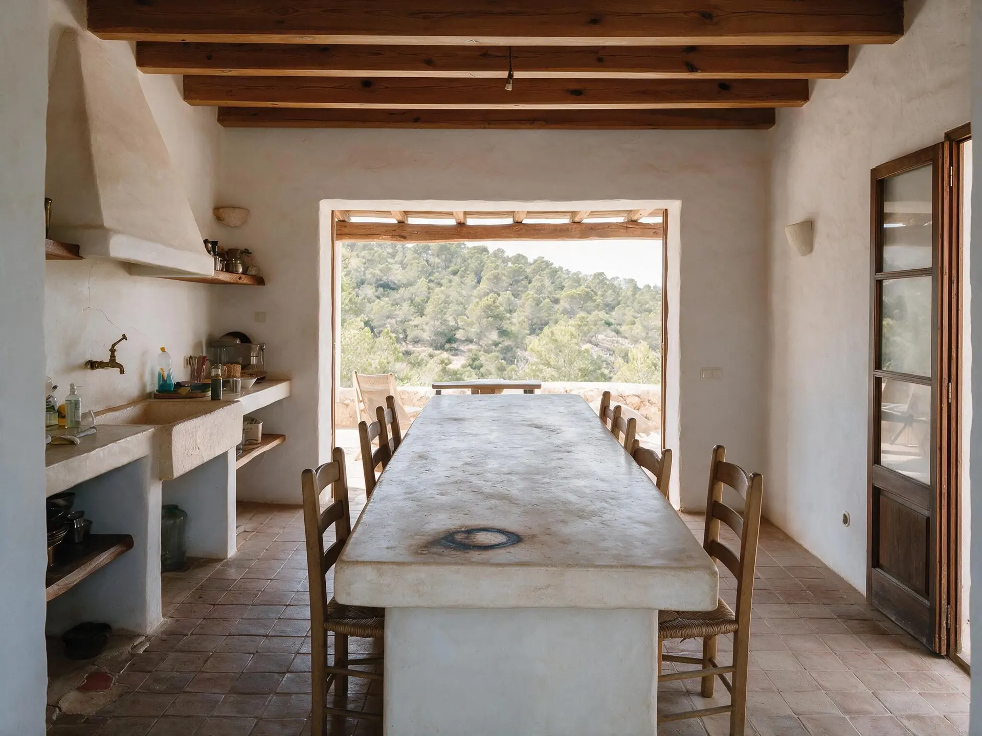 Before and after of a stone finca kitchen and great room in San Jose, Ibiza, with clutter removed.