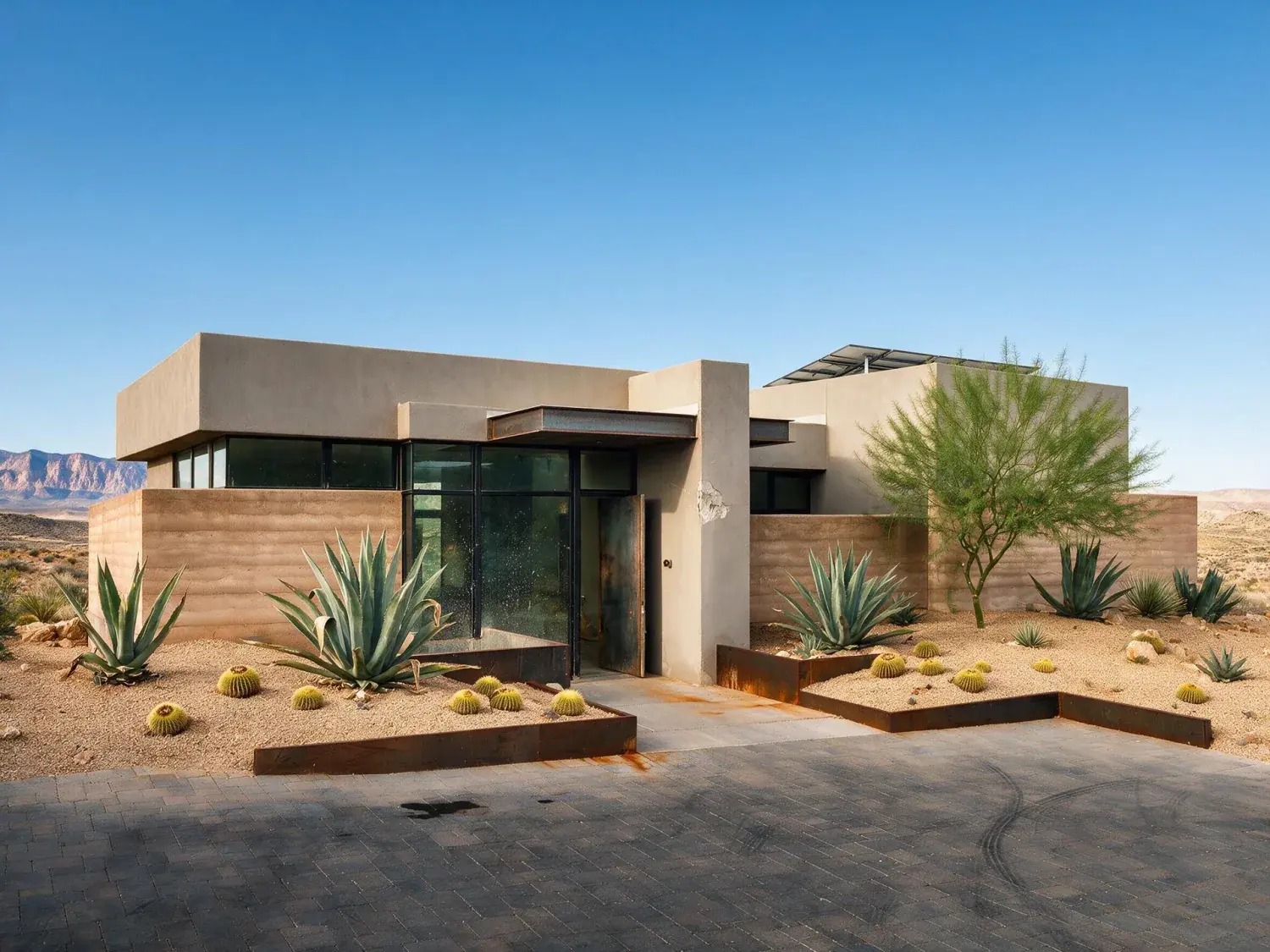 Before and after of front exterior of a summerlin the ridges desert-modern estate with a blown-out white mojave sky replaced by natural nevada desert blue while preserving the red rock escarpment silhouette — enhanced by Plotpane