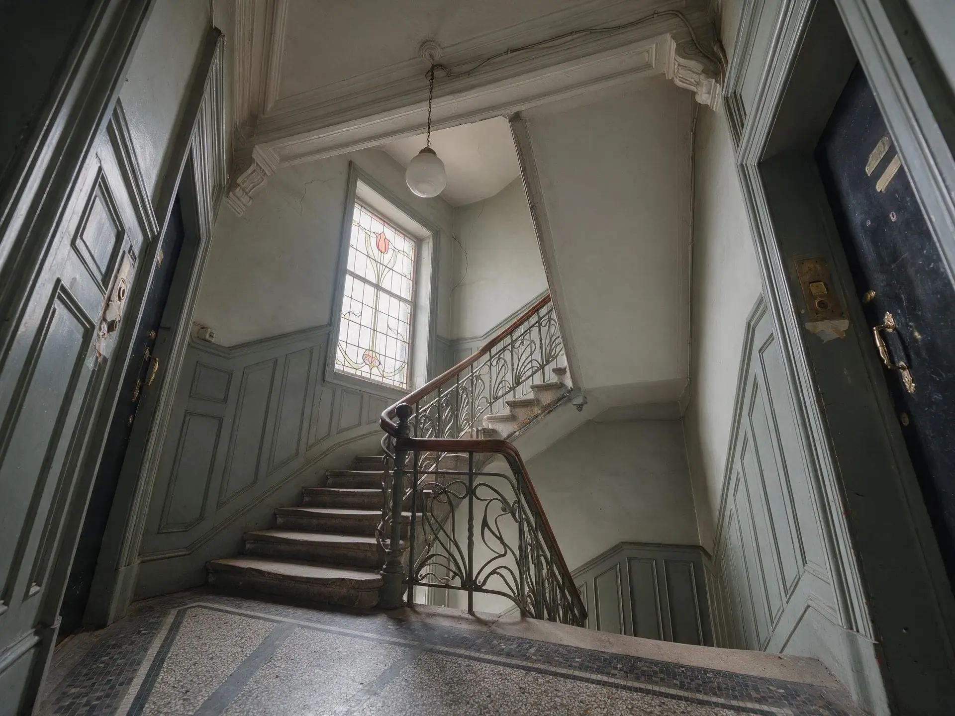 Before and after of a Jugendstil apartment-house stairwell in Seefeld, Zurich, with leaning verticals straightened. — original listing photo before editing