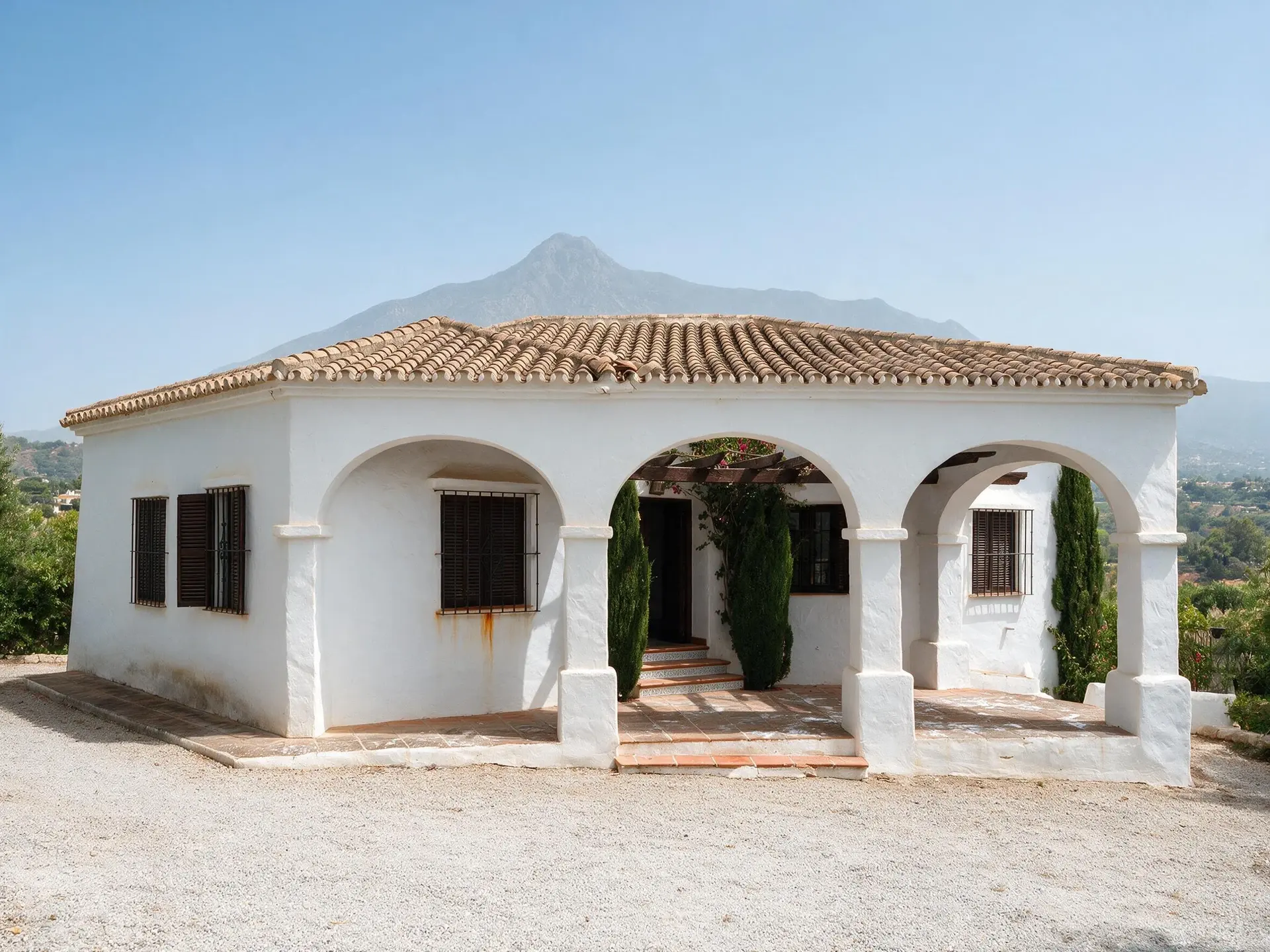 Before and after of an Andalusian villa exterior in Nueva Andalucía, Marbella, with the sky replaced. — enhanced by Plotpane