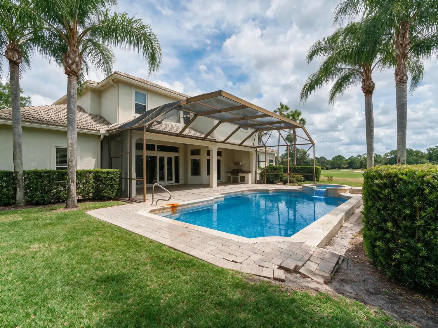 Before and after of rear exterior of a lake nona golf & country club estate with heat-stressed st. augustine lawn and green-tinged pool recovered to healthy turf and clear caribbean-blue water — enhanced by Plotpane