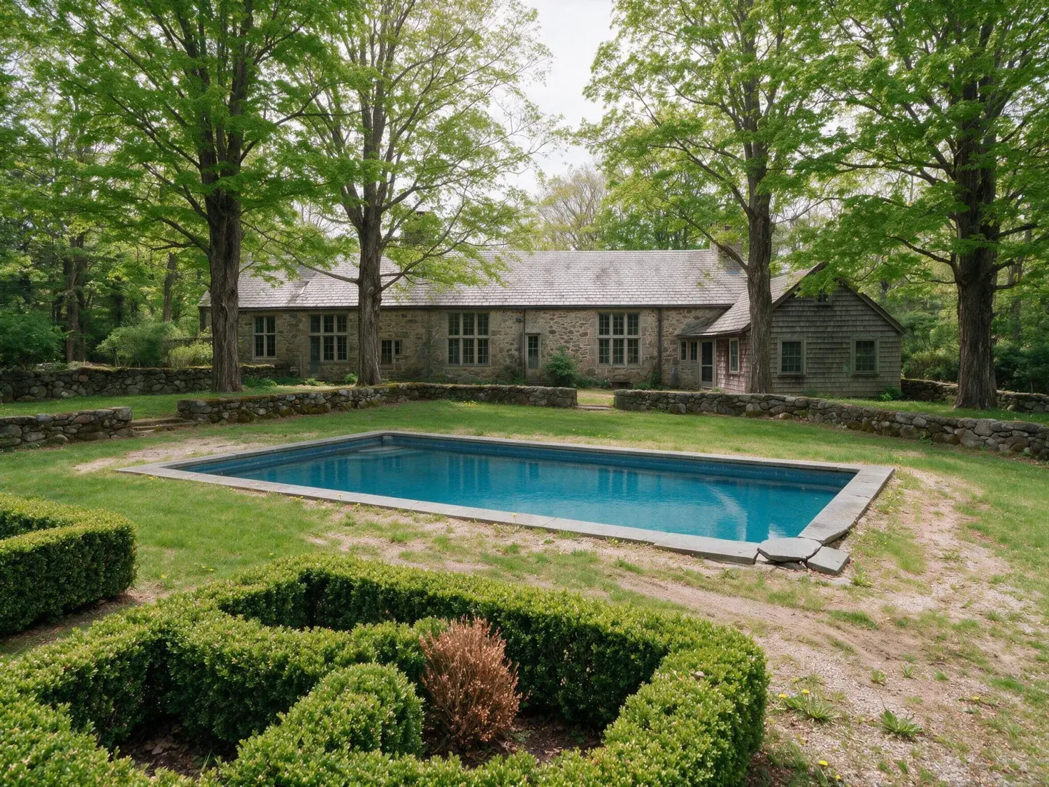 Before and after of a hand-laid stone manor in greenwich back-country commands a restored emerald meadow, its pool a polished slate rectangle in the turf — enhanced by Plotpane