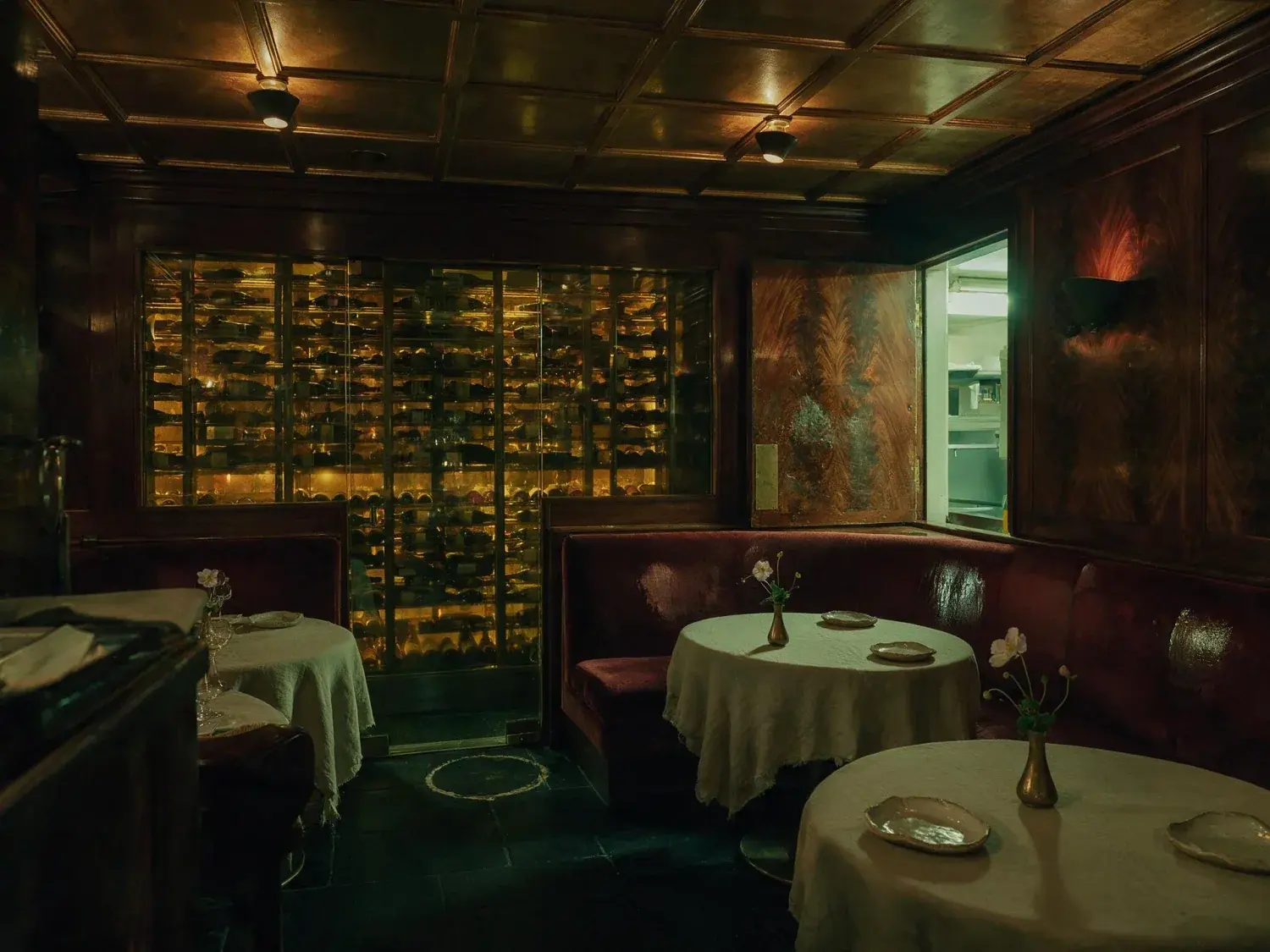 Before and after of a dark, intimate michelin-starred dining room recovers its velvet depth and glinting crystal without losing its secret-club shadow — original listing photo before editing