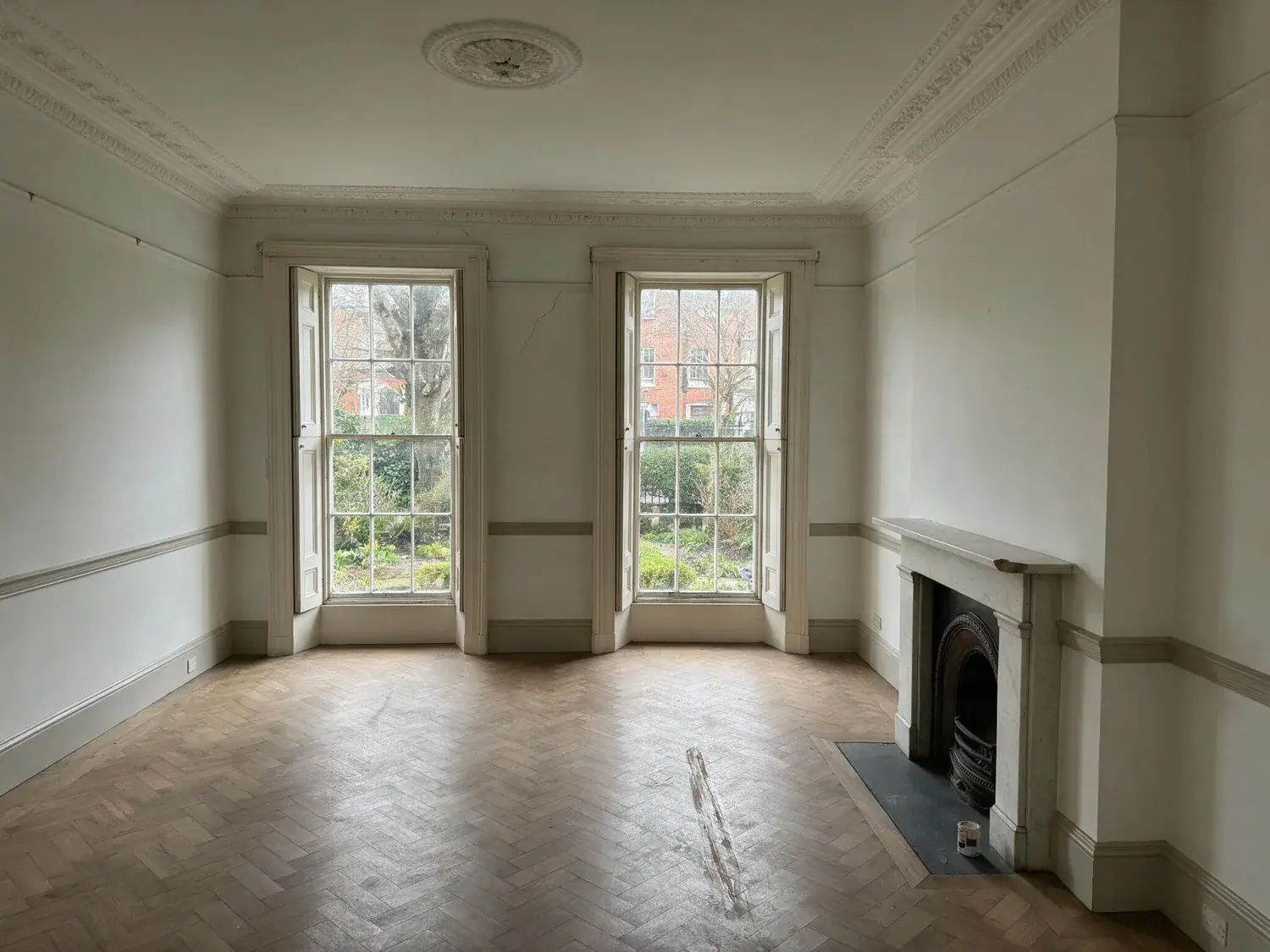 Before and after of a vacant principal drawing room in a ballsbridge georgian townhouse staged into the house & home ireland cover hero — original listing photo before editing