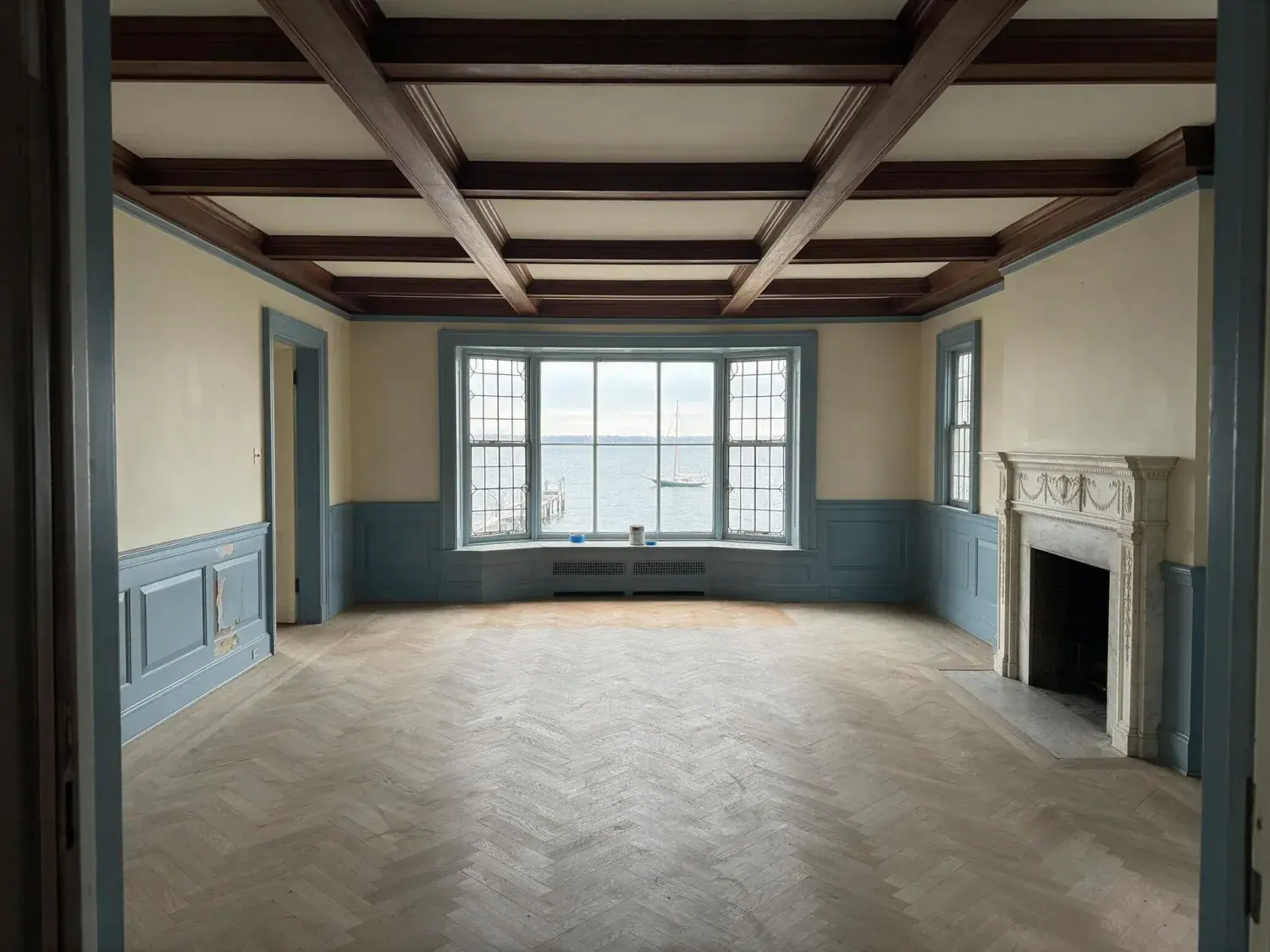 Before and after of a fully vacant belle haven shingle-style waterfront drawing room — echoing empty — transforms into a warm, transitional-coastal family room staged for a $14m listing cover shot — original listing photo before editing