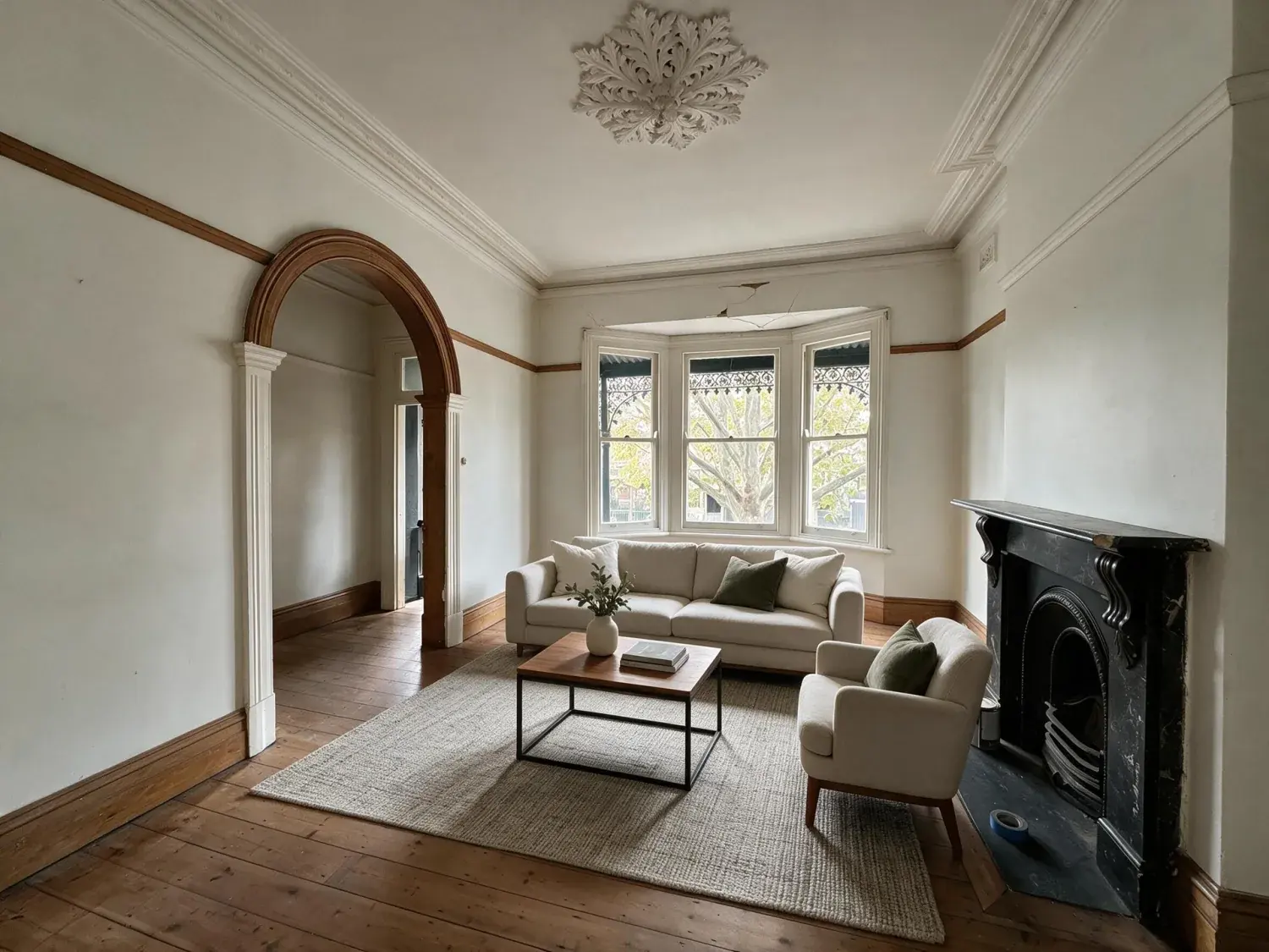 Before and after of a vacant front lounge of a single-fronted victorian terrace on a leafy south yarra street staged into the belle / vogue living australia auction-campaign hero — enhanced by Plotpane