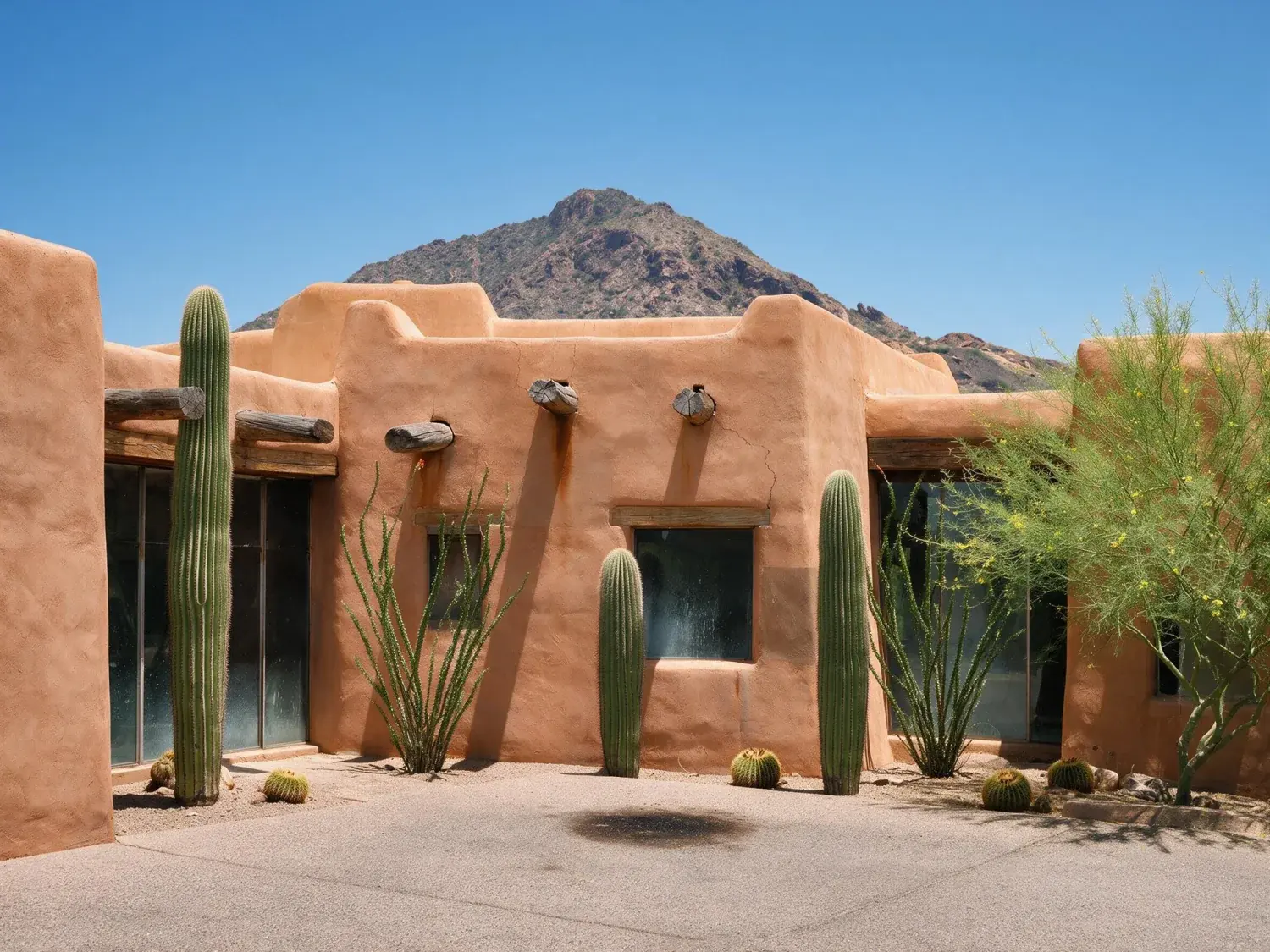 Before and after of a rammed-earth and adobe paradise valley estate under a bleached arizona noon — reset against a sonoran cerulean with saguaro-perfect edges — enhanced by Plotpane