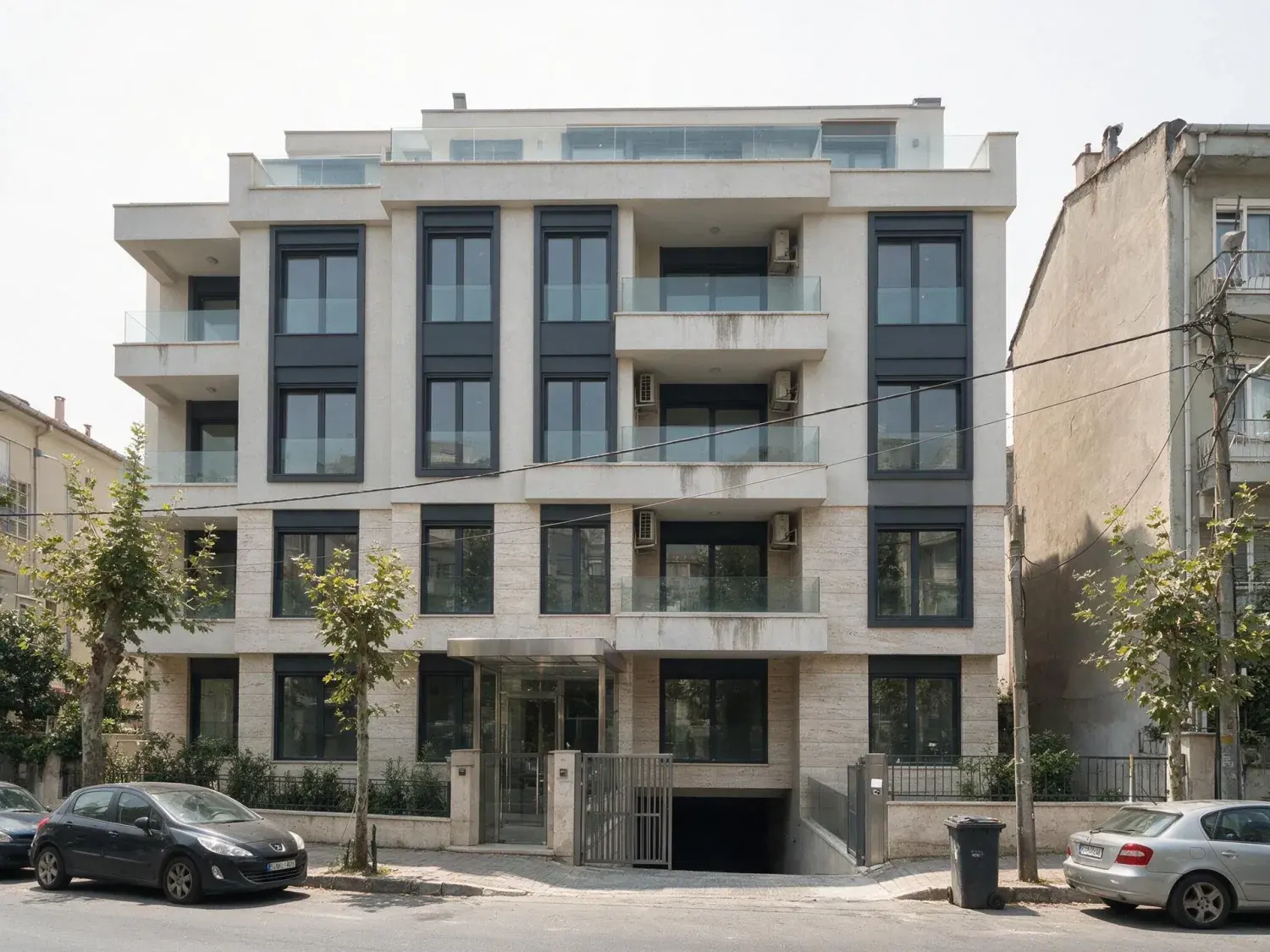 Before and after of a new bağdat caddesi kentsel dönüşüm block photographed under a blown-out white summer overcast — original listing photo before editing