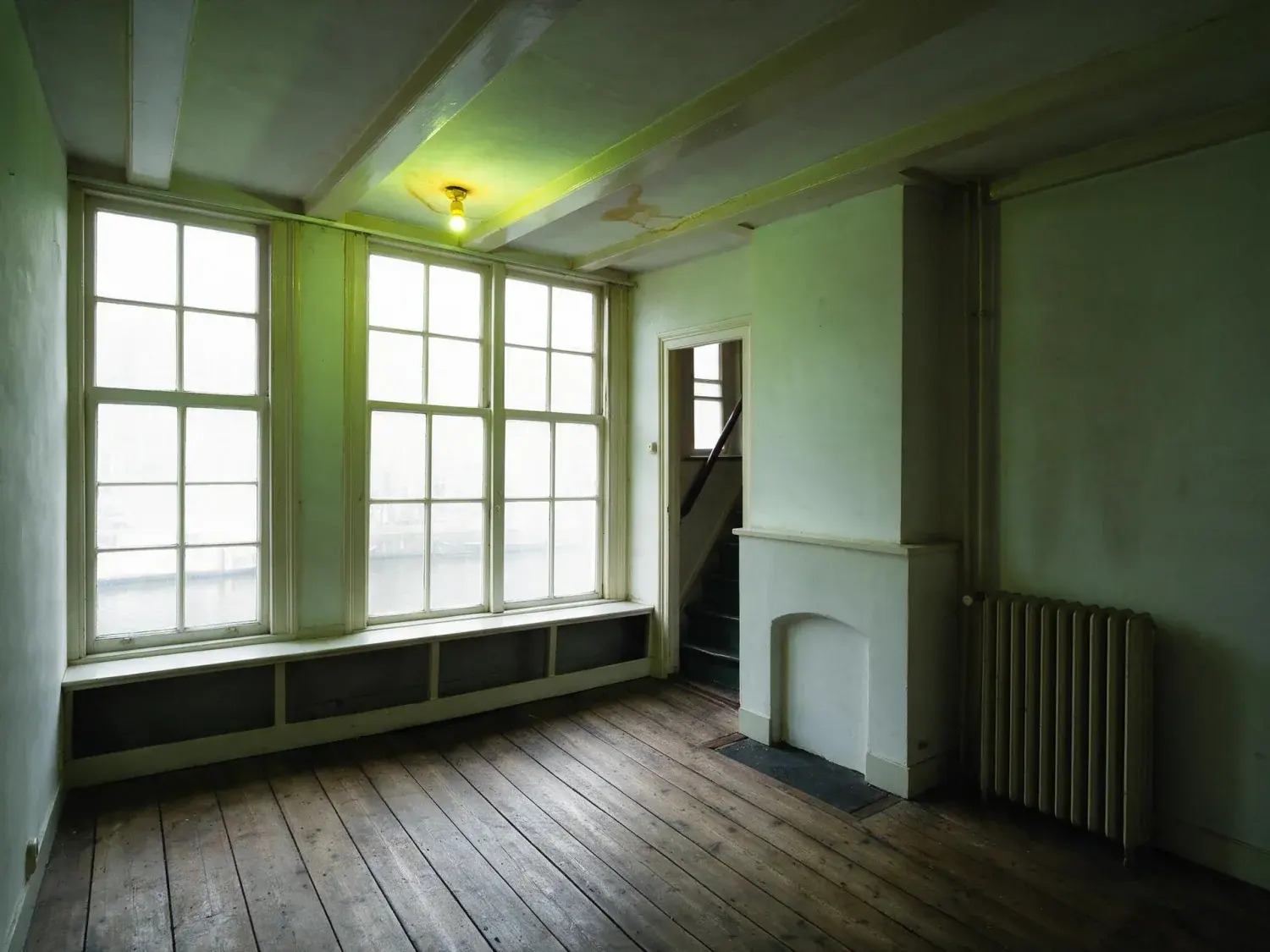 Before and after of an amsterdam canal-house front room shot into the light, so the windows are white and the room behind them is nearly black — original listing photo before editing