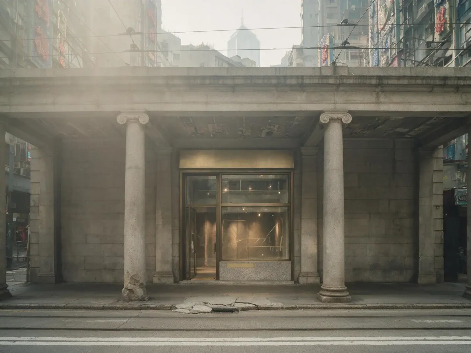 Before and after of a central hong kong boutique retail unit recovers its granite colonnade and colour-saturated signage backdrop from a flat, haze-dimmed street capture — original listing photo before editing