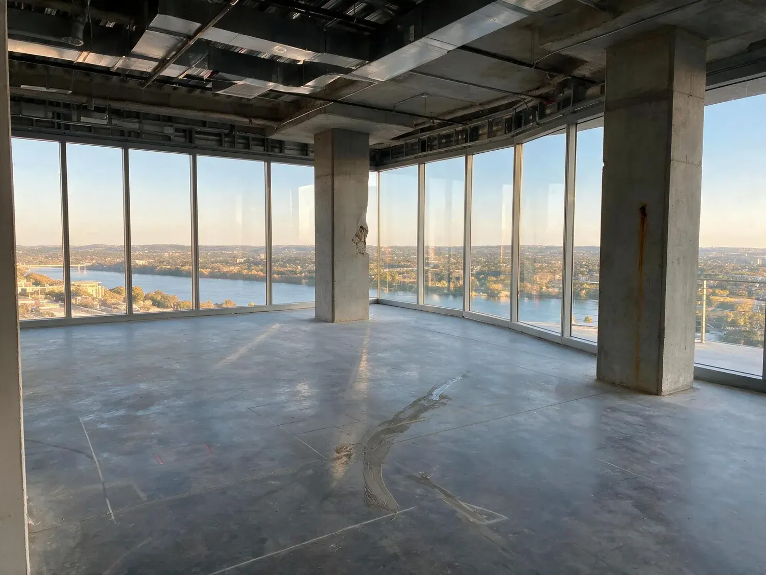 Before and after of a bare austin downtown penthouse shell is renovated into a hill-country-modern residence, keeping the existing lake-and-horizon view intact — enhanced by Plotpane