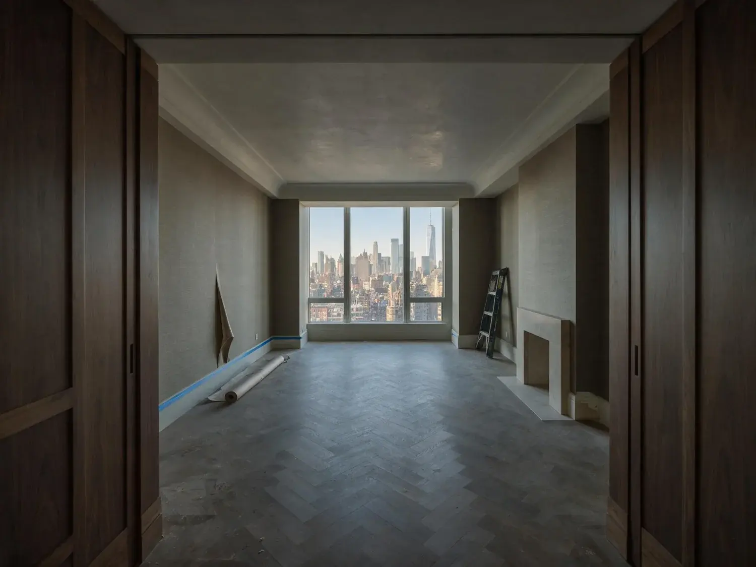 Before and after of an empty high-floor four seasons downtown studio is dressed as a residential sanctuary, its skyline window newly framed by editorial furniture — original listing photo before editing