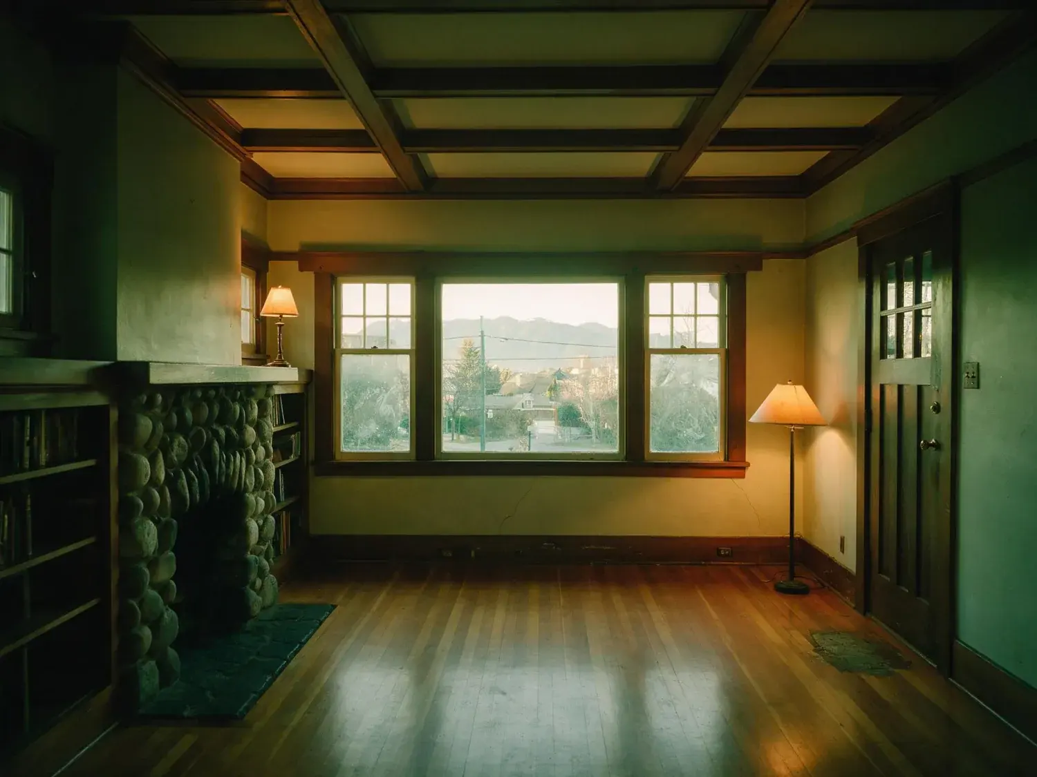 Before and after of a Kitsilano Craftsman room, flat and dim with the window burnt to white. — original listing photo before editing