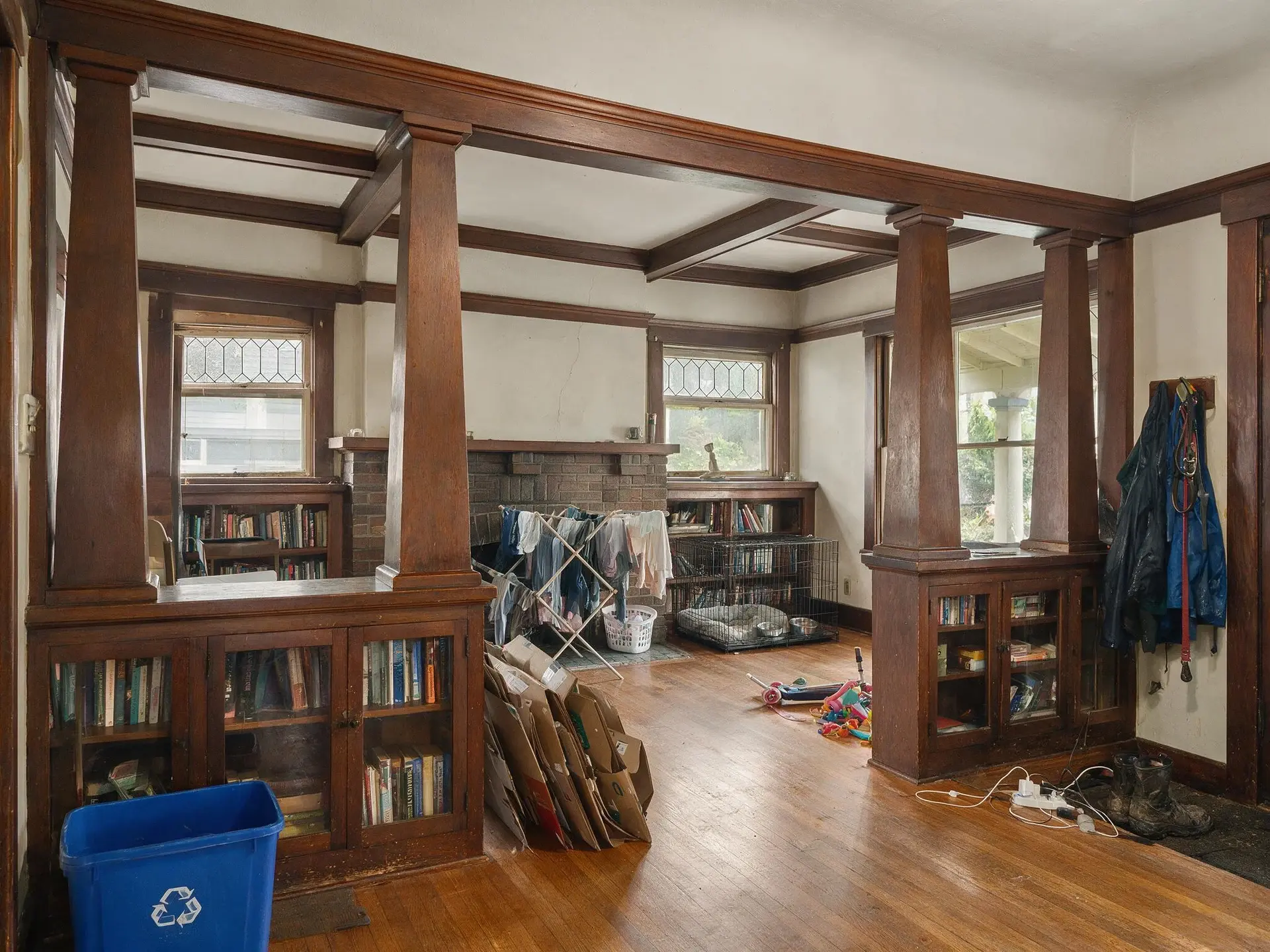 Before and after of a cluttered Craftsman living room on Queen Anne hill, Seattle. — original listing photo before editing