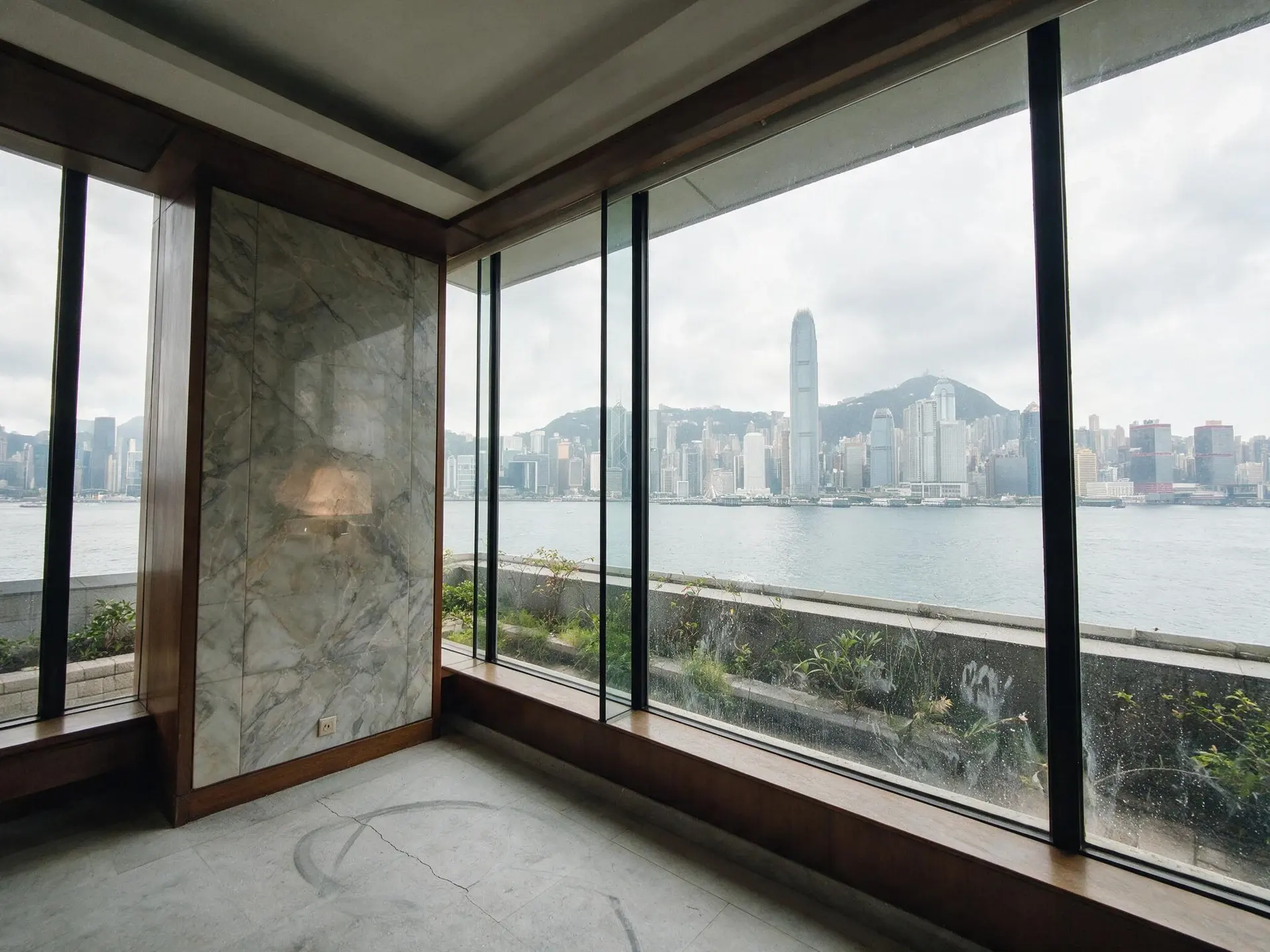 Before and after of a terrace apartment interior above Victoria Harbour on The Peak, Hong Kong. — original listing photo before editing