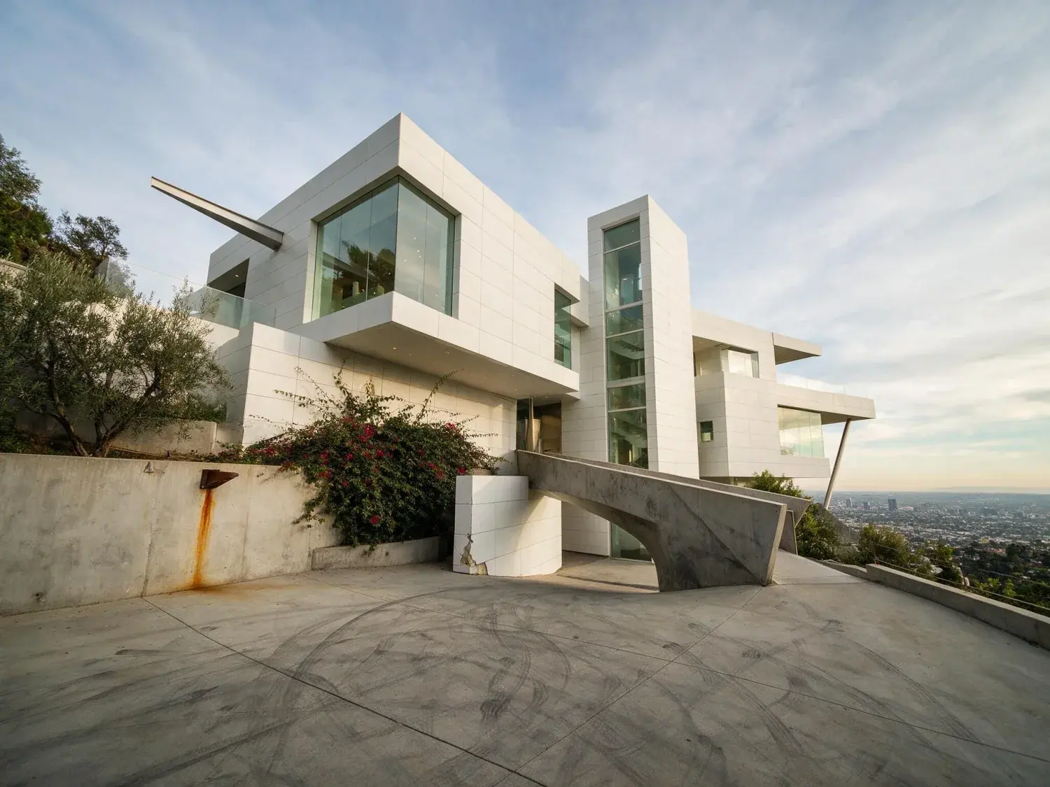 Before and after of a stacked white bel air mansion clings to the ridge, its orthogonal volumes corrected into pure architectural geometry — original listing photo before editing