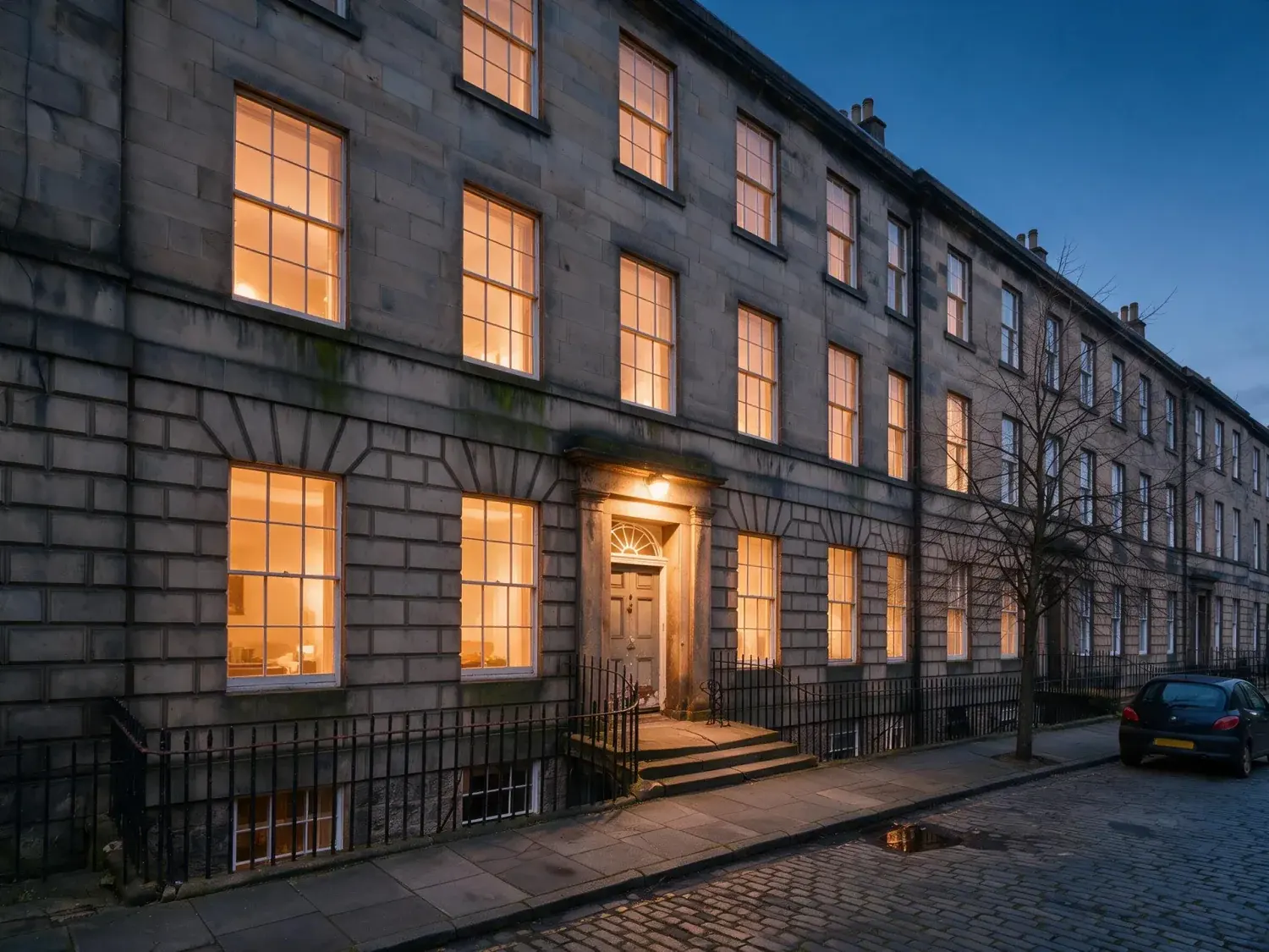 Before and after of a north-facing craigleith-sandstone georgian terrace in edinburgh's new town, captured flat and grey, relit to civil twilight — enhanced by Plotpane