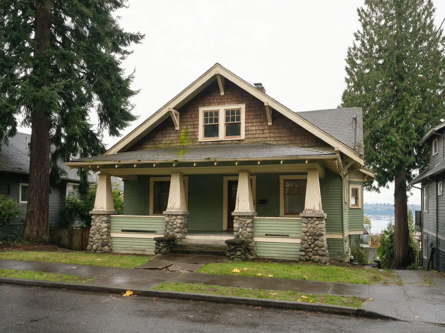 Before and after of a 1912 capitol hill craftsman with deep eaves and a lake union view, rescued from seattle's flat grey sky into a crisp rainier-visible pnw clear-day frame — original listing photo before editing