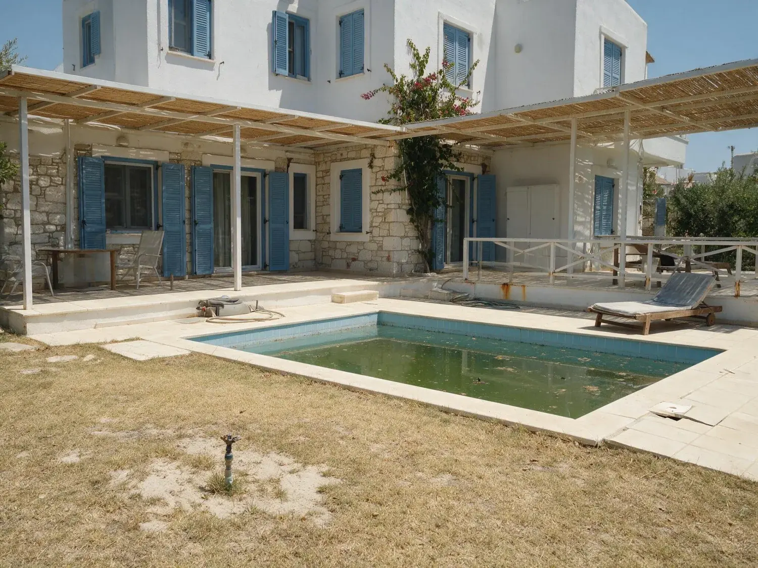 Before and after of the garden of an alaçatı summer villa at the end of a hot season, with a burnt lawn and a green pool — original listing photo before editing