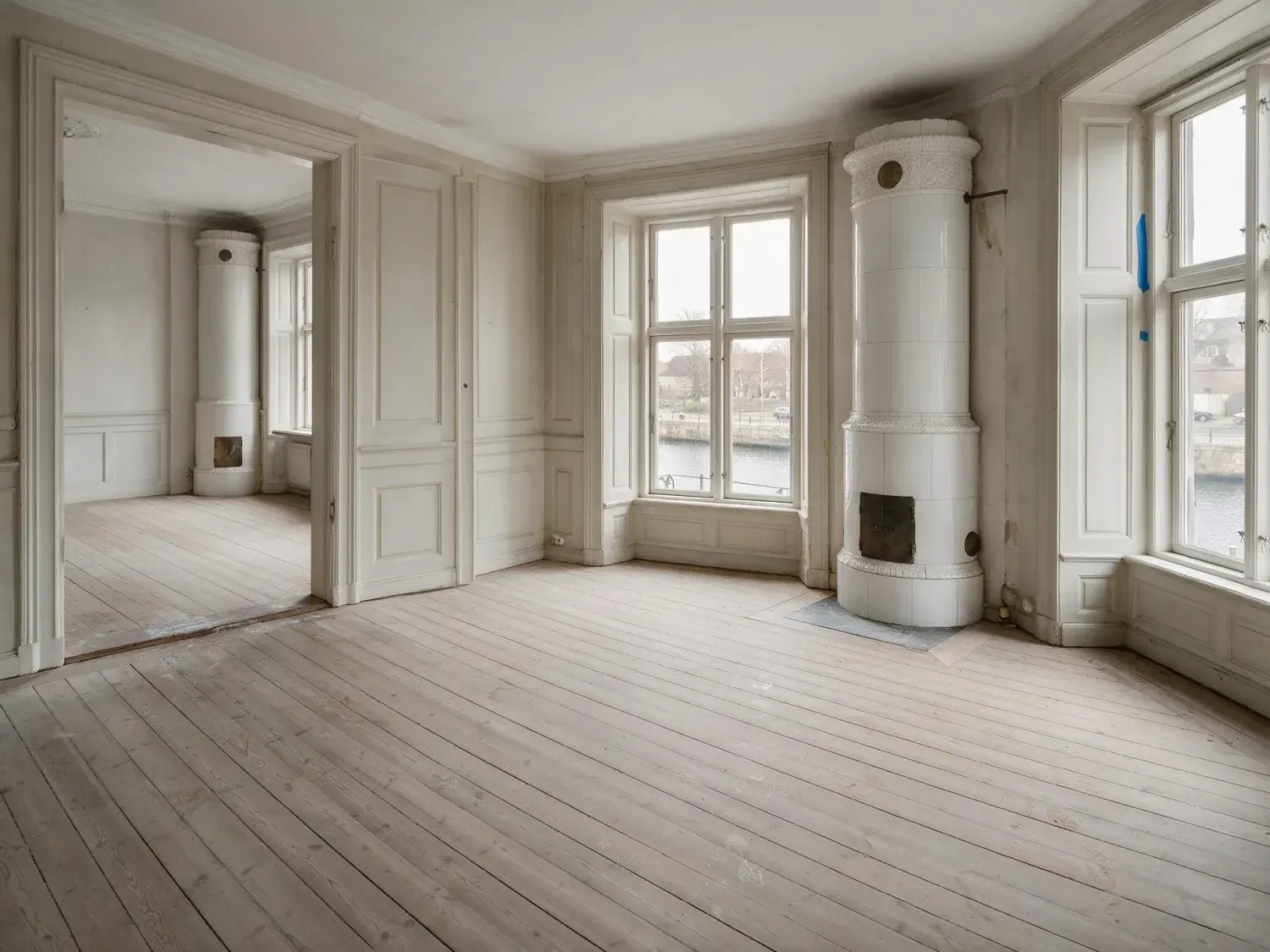 Before and after of an empty Frederiksstaden salon over the canal. — original listing photo before editing