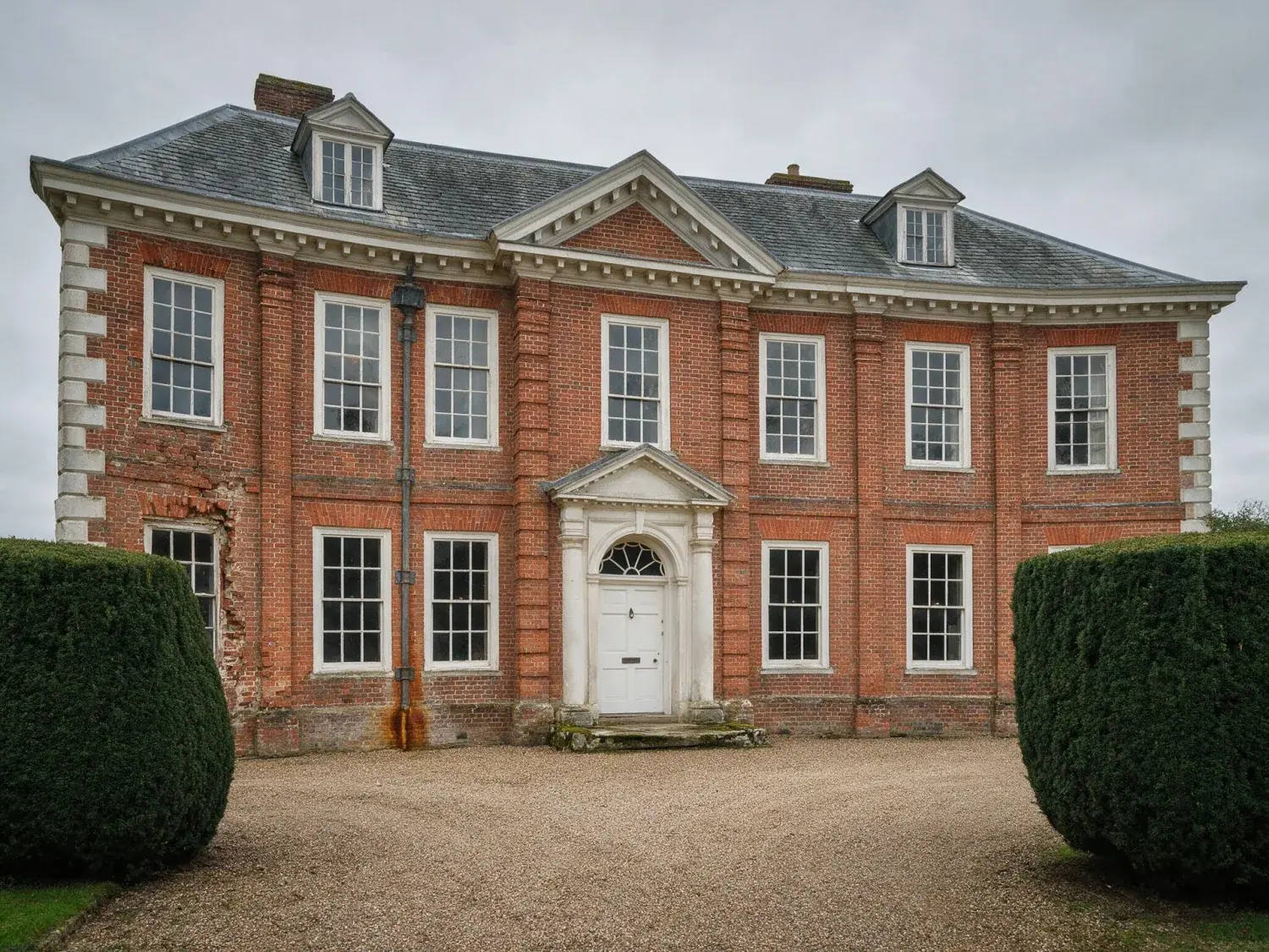 Before and after of a five-bay georgian manor, its classical symmetry restored after a careless handheld tilt flattened its grandeur — original listing photo before editing