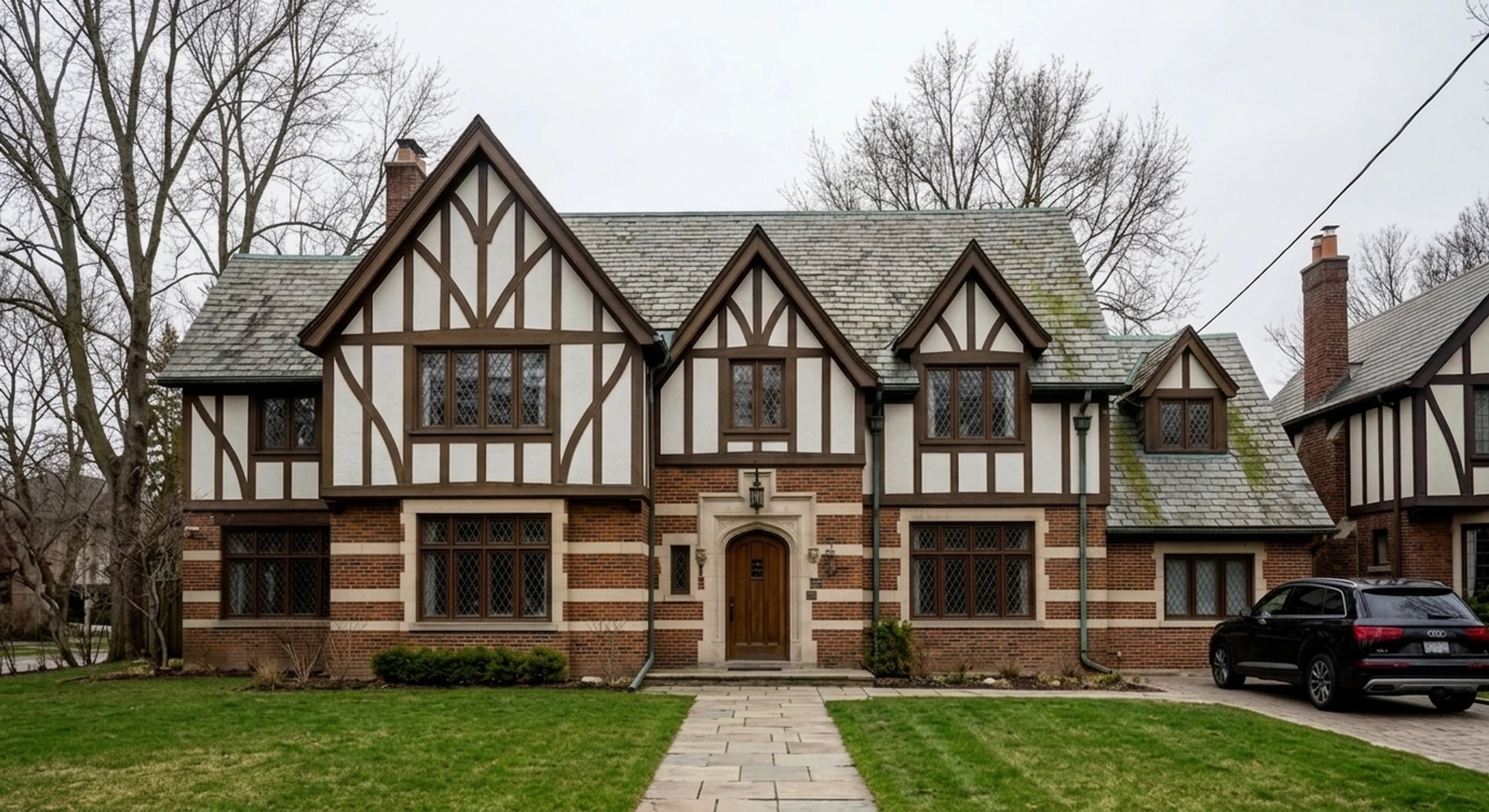 A 1920s Rosedale Tudor-revival estate captured under flat Great-Lakes overcast, recovered into a Realtor.ca / Sotheby's Canada premium hero. — enhanced by Plotpane